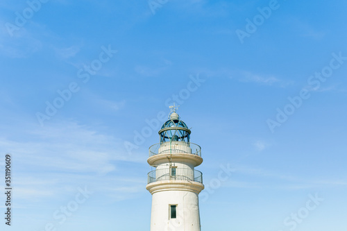Lighthouse on blue sky in summer time. Concept: vacations, summer.