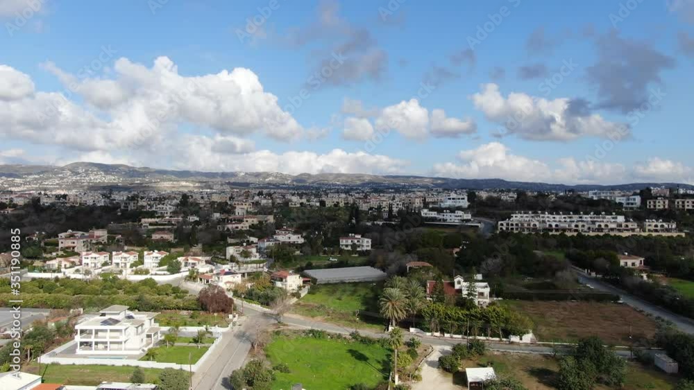 Drone view of gorgeous tourist resort under blue summer sky on Cyprus. Aerial view of luxurious buildings on hills next to Mediterranean Sea. Luxury tourism, nature, landscape. Drone view of gorgeous tourist resort under blue summer sky on Cyprus. Aerial view of luxurious buildings on hills next to Mediterranean Sea. Luxury tourism, nature, landscape.