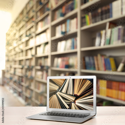 Papier peint bibliothèque - Papier peint Digital library concept. Modern laptop on table indoors
