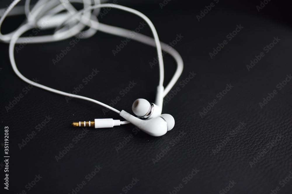 smartphone headphones are white on a black background smartphone headphones are white on a black background