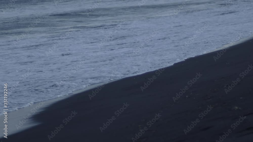 Calm tide waves on volcanic coast from Iceland