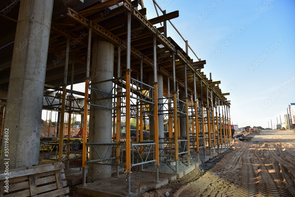 Naklejka premium Bridge construction project works. Roundabout traffic bridge construction and highway ramps. Road work on traffic highway, road intersection junction and freeway