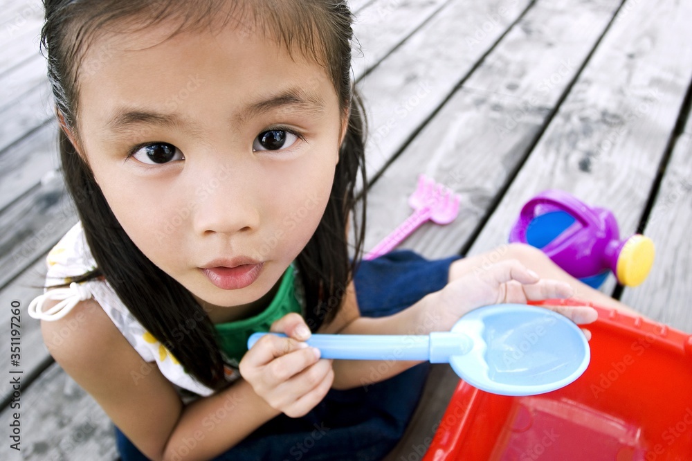 Girl playing with her beach toy Girl playing with her beach toy