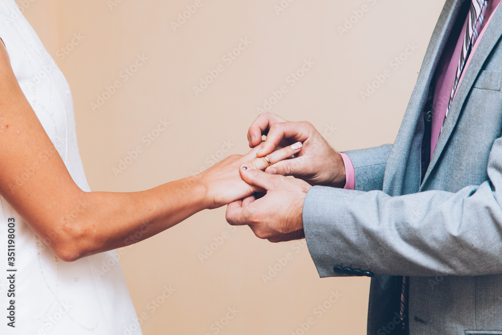 hands of a couple of bride and groom exchanging wedding rings hands of a couple of bride and groom exchanging wedding rings
