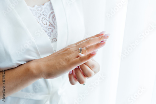 hands of the bride and wedding rings, shoulder of the bride 