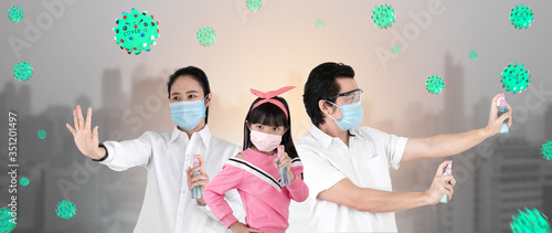 Asian family on city background are strengthening to overcome the virus Covid-19 by wearing a mask and carrying alcohol bottles for washing hands, cleaning or spraying infected items.