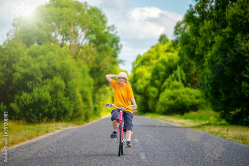 Young girl in a hat on a bicycle
