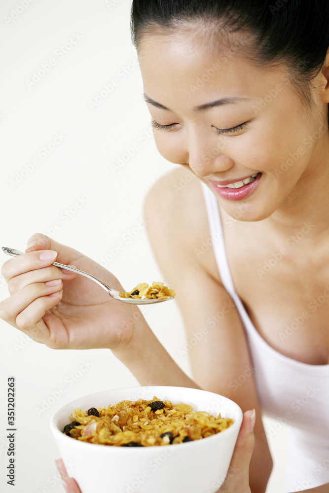 Woman enjoying her breakfast cereal Woman enjoying her breakfast cereal