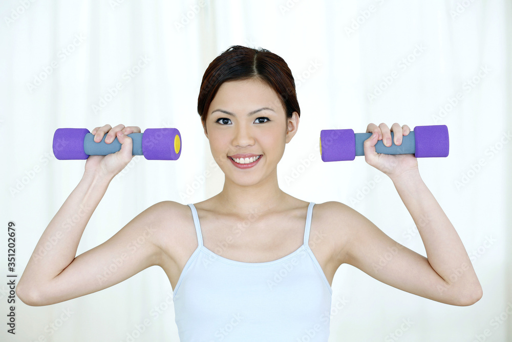 Woman lifting dumbbell Woman lifting dumbbell