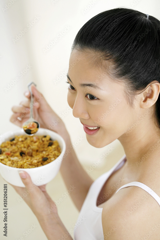 Woman enjoying her breakfast cereal Woman enjoying her breakfast cereal