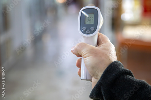 electronic thermometer in the hand with normal temperature