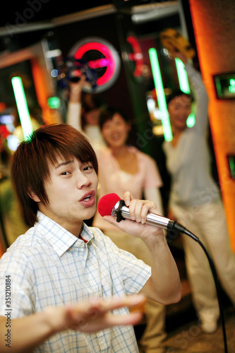 Man singing into microphone © ImageHit