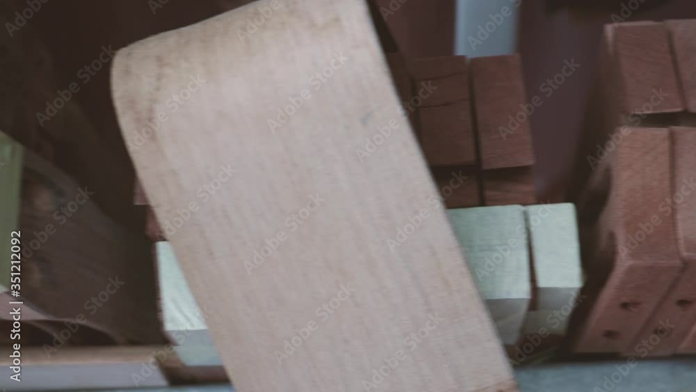 Rack of unfinished handmade wooden guitar heads. Handheld panning shot Rack of unfinished handmade wooden guitar heads. Handheld panning shot