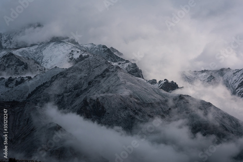 View of snow mountain surrounded by clouds with morning fog