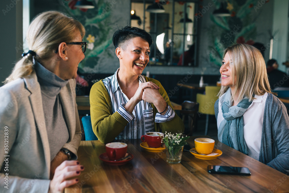 women friends having coffee break at cafe