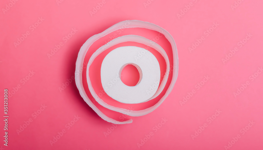 Conceptual image of toilet paper roll standing alone at pastel background. Roll of toilet paper on a pastel pink background. Coronavirus covid-19 design. Conceptual image of toilet paper roll standing alone at pastel background. Roll of toilet paper on a pastel pink background. Coronavirus covid-19 design.