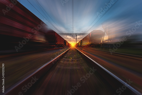 freight, passenger train moves with speed by rail