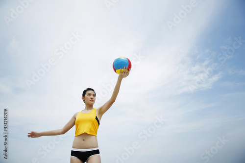 Woman serving volleyball