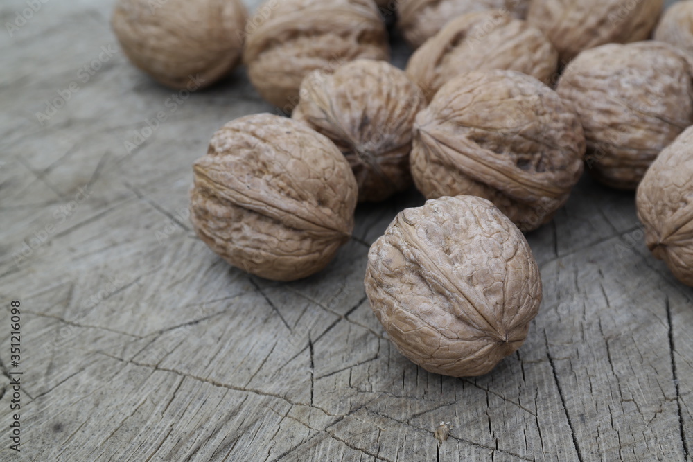 walnuts on wooden table walnuts on wooden table