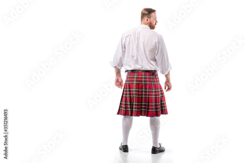 back view of Scottish redhead man in red kilt on white background