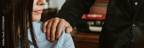 Tablou pe pânză Businessman patting a colleague on her shoulder