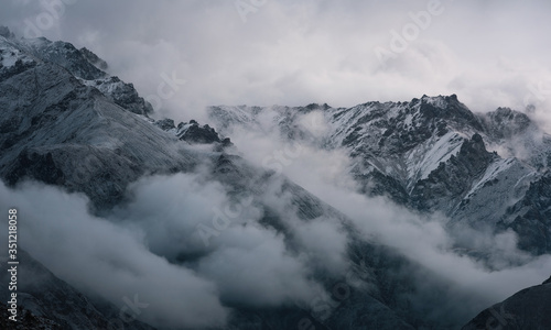 View of snow mountain surrounded by clouds with morning fog