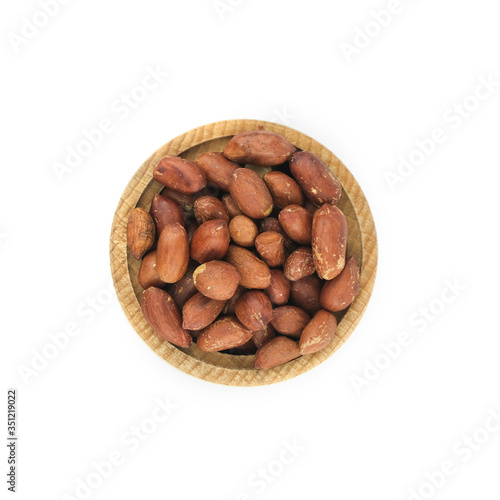 Peanuts in wood bowl close up isolated on white background..