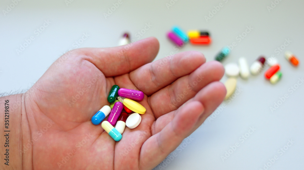 Obesity patient take medicine colorful tablets, pills and capsules in hand for treatment and cure disease or sickness. Drug prescription use for medication in medical clinic, pharmacy service concept. Obesity patient take medicine colorful tablets, pills and capsules in hand for treatment and cure disease or sickness. Drug prescription use for medication in medical clinic, pharmacy service concept.