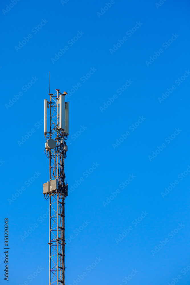 Mobile communications antenna against a blue sky Mobile communications antenna against a blue sky
