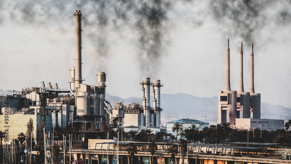 Fototapeta premium Industry skyline with smoking chimneys with polluted sky.