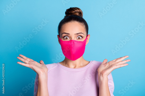 Portrait photo of pretty lady keep social distance people contacting responsible citizen crazy expression raise arms good news wear protect face mask sweater isolated blue color background