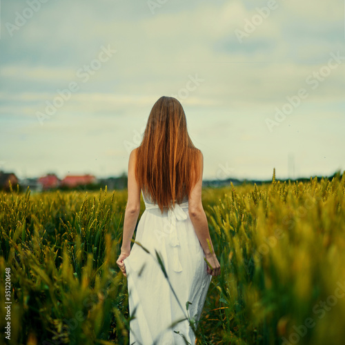 thoughtful girl in a dress in the back standing