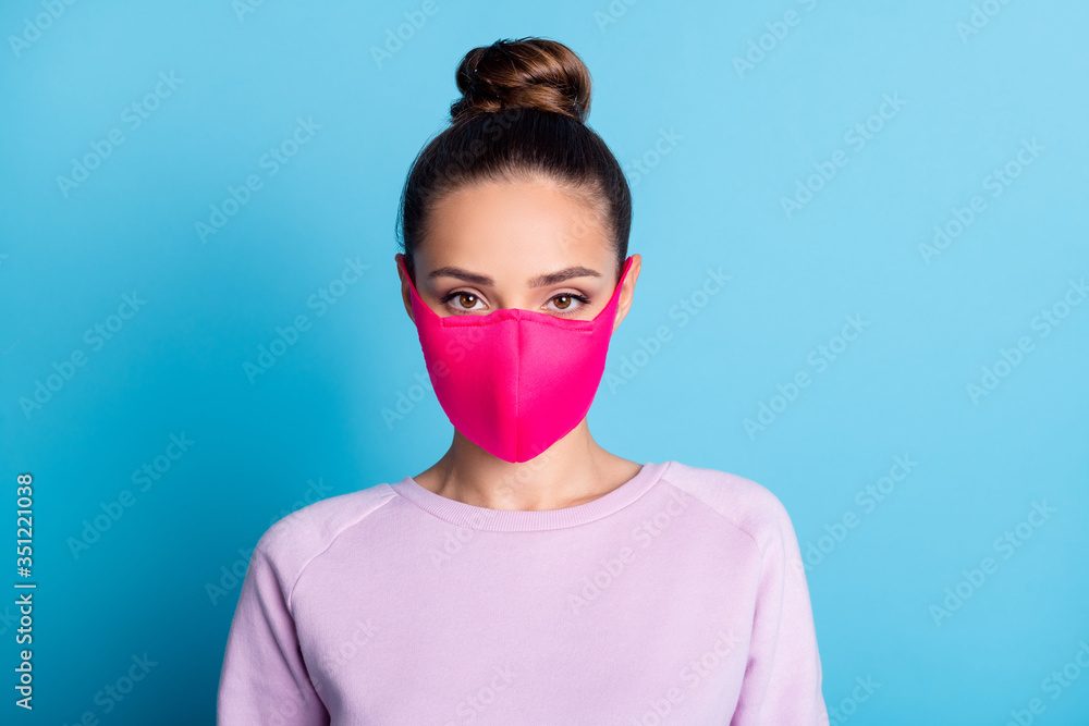 Portrait photo of pretty lady keep social distance avoid people contacting responsible citizen serious facial expression wear protect bright face mask sweater isolated blue color background Portrait photo of pretty lady keep social distance avoid people contacting responsible citizen serious facial expression wear protect bright face mask sweater isolated blue color background