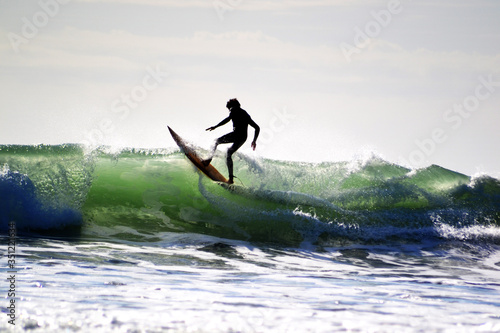 Raglan, New Zealand - March 2016: Surfing The Beach in Raglan