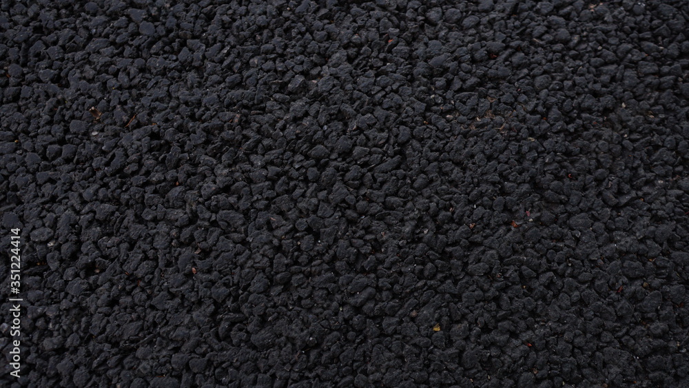 Fresh asphalt. Black structural background. Side view Fresh asphalt. Black structural background. Side view
