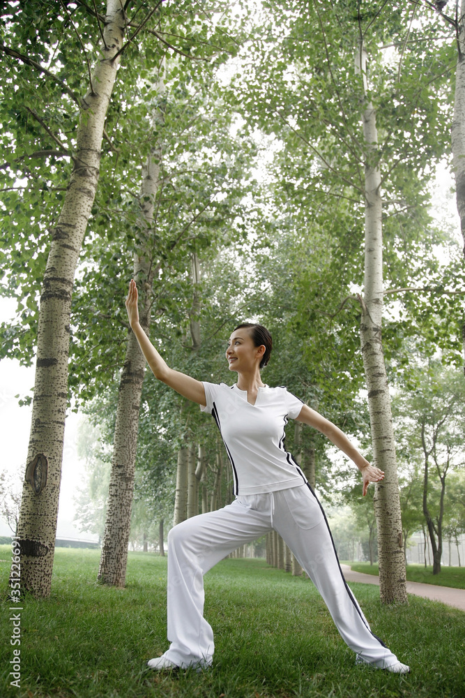 Woman practising tai chi in the park