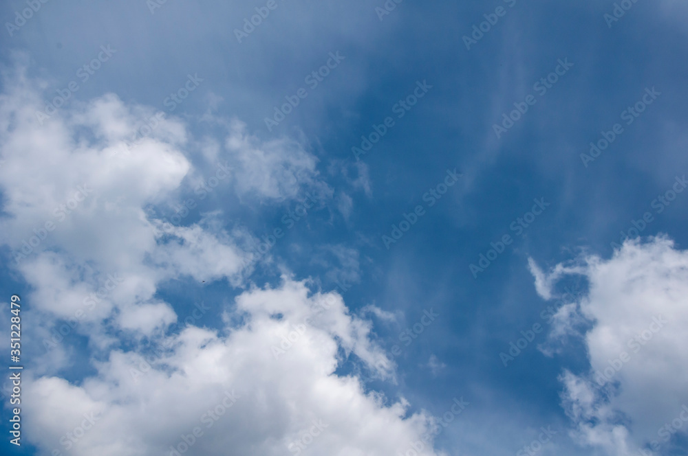 White clouds on a blue sky. Beautiful natural background White clouds on a blue sky. Beautiful natural background
