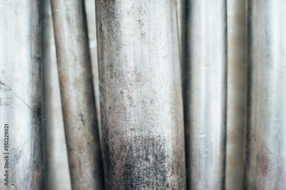 Stainless steel scrap metal, stainless steel pipes on the background of a stainless steel sheet. Close-up. Macro. Stainless steel scrap metal, stainless steel pipes on the background of a stainless steel sheet. Close-up. Macro.