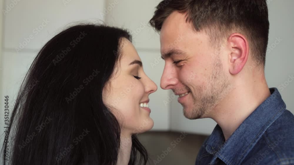 Man and women have flirting in the modern white kitchen.Hugging in the kitchen. Man and women have flirting in the modern white kitchen.Hugging in the kitchen.