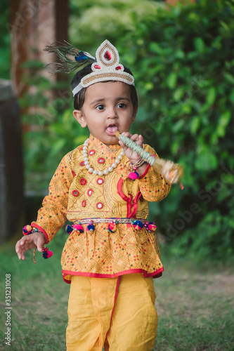 Indian Little child wearing Lord Krishna costume and celebration Janmashtami festival