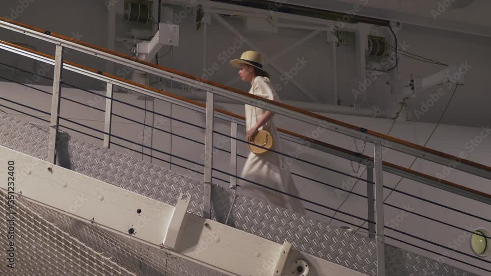 Young girl climbing the stairs to the ship. Shot on Black Magic Cinema Camera Young girl climbing the stairs to the ship. Shot on Black Magic Cinema Camera