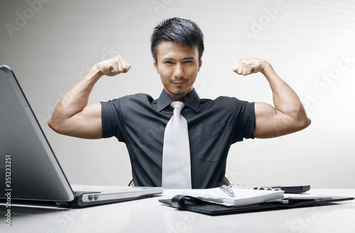 Businessman showing off his muscle