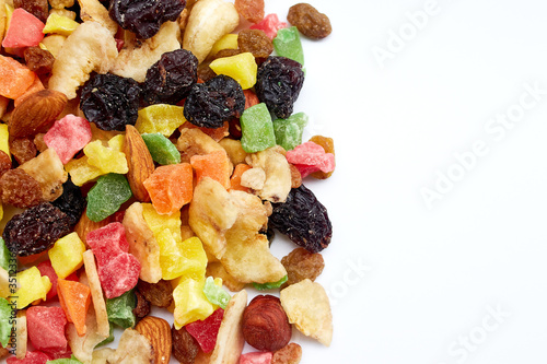 Assorted different dried sweets. Dried bananas, grapes, nuts. On the left.