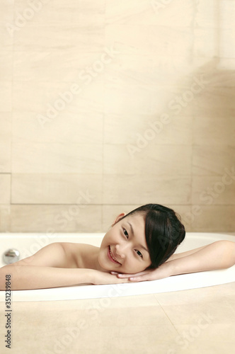Woman in the bathtub  smiling at the camera
