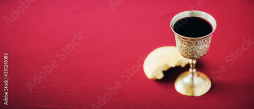 Konstfotografi Unleavened bread, chalice of wine, silver kiddush wine cup on red background