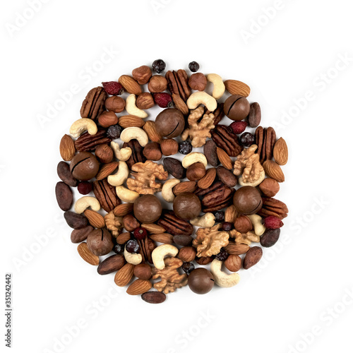 On an isolated background, different nuts are placed in a circle. Close-up. view from above.