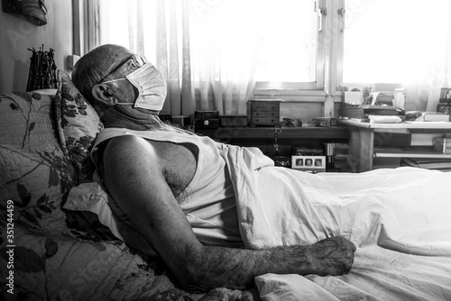 Black and white face of old man with face mask