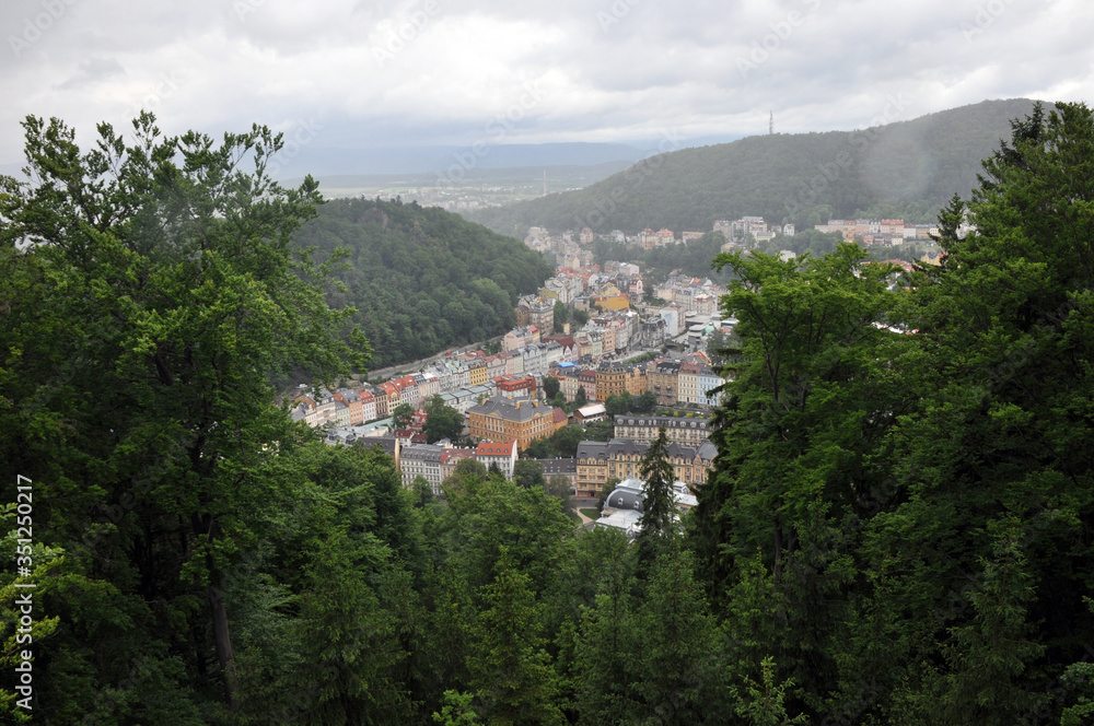 Neighborhoods of residential buildings in the historical part of Karlovy Vary surrounded by wooded hills
