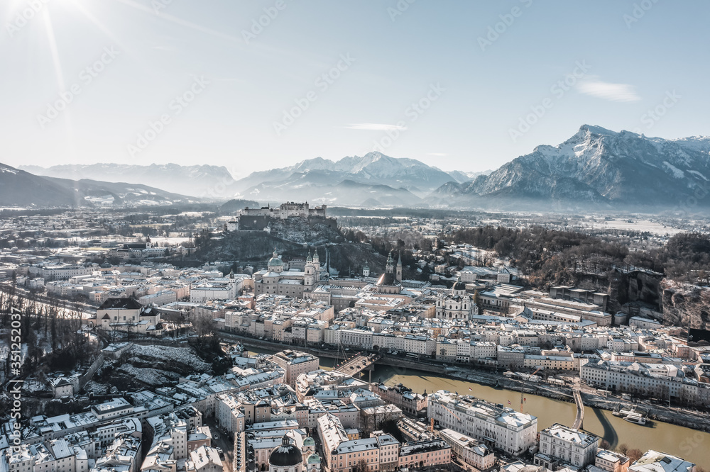 Aerial drone view of Salzburg snowy north town with view of Unesberg mountain in winter morning