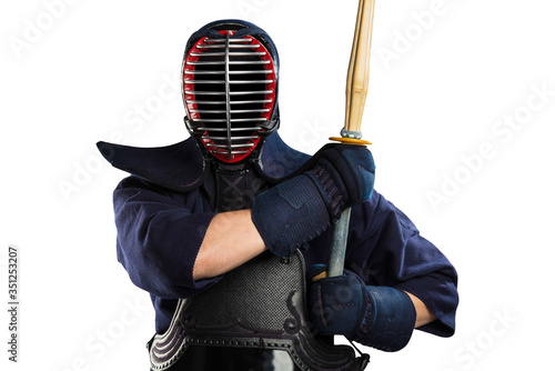 Male in tradition kendo armor with bamboo sword on white background. (unrecognizable person, dark mask) Shot in studio. Isolated with clipping path.